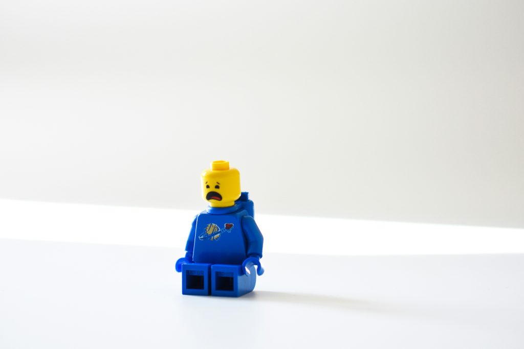 An unhappy lego sitting on the counter